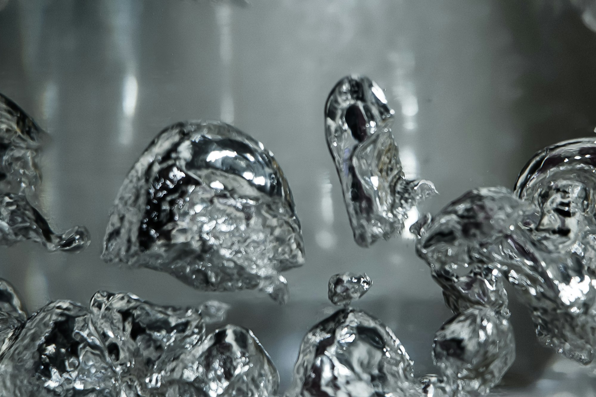 Drops and bubbles of mercury in water. Dangerous chemical element, the scientific experience.