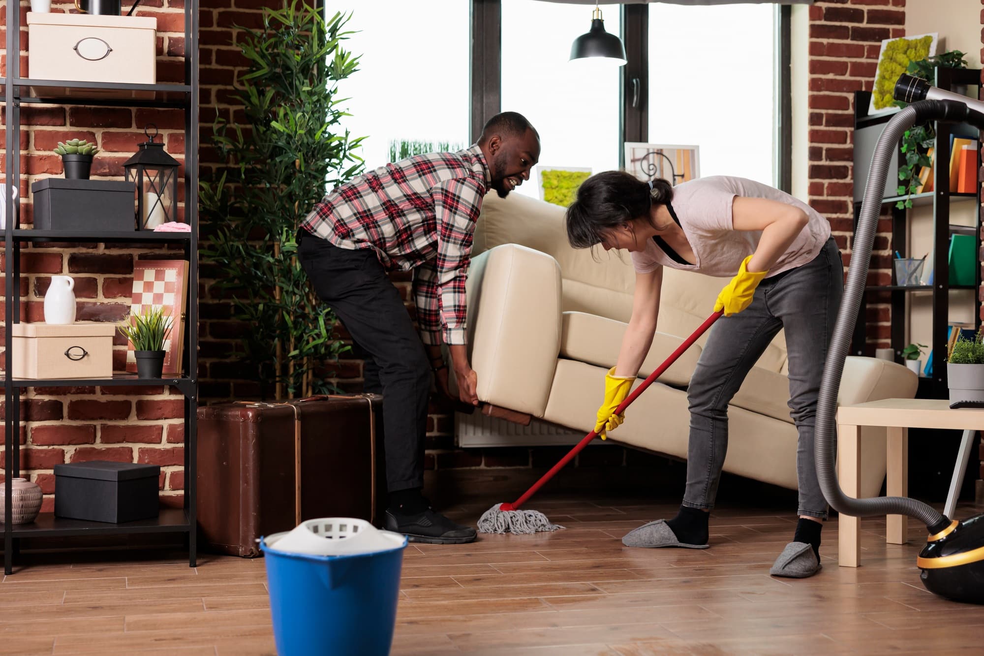 Multiracial couple doing spring cleaning